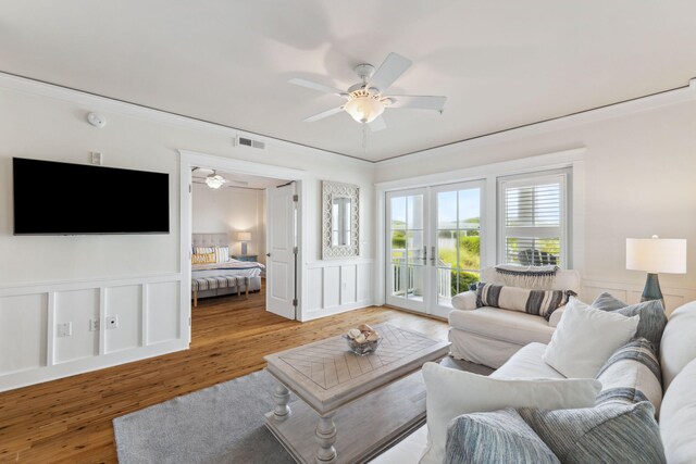 1848 E County Highway 30a Unit 4, Santa Rosa Beach, FL 32459 - living area featuring a ceiling fan, light wood-style floors, a decorative wall, and a wainscoted wall