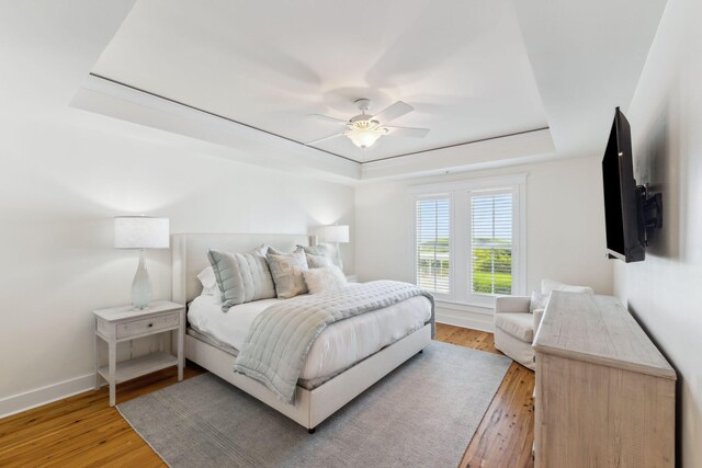 1848 E County Highway 30a Unit 4, Santa Rosa Beach, FL 32459 - bedroom featuring a raised ceiling, light wood-style floors, baseboards, and a ceiling fan
