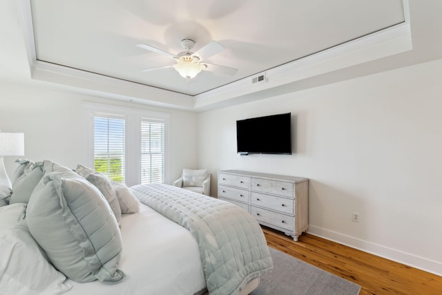 1848 E County Highway 30a Unit 4, Santa Rosa Beach, FL 32459 - bedroom featuring a tray ceiling, baseboards, light wood finished floors, and a ceiling fan