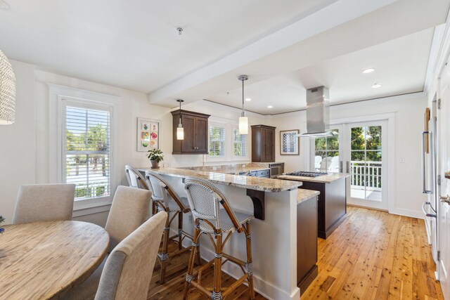 1848 E County Highway 30a Unit 4, Santa Rosa Beach, FL 32459 - kitchen featuring island range hood, dark brown cabinets, a peninsula, healthy amount of natural light, and recessed lighting