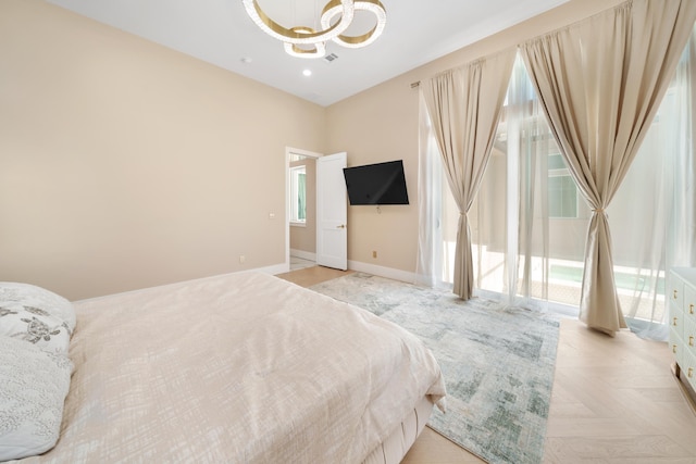 bedroom with baseboards and an inviting chandelier