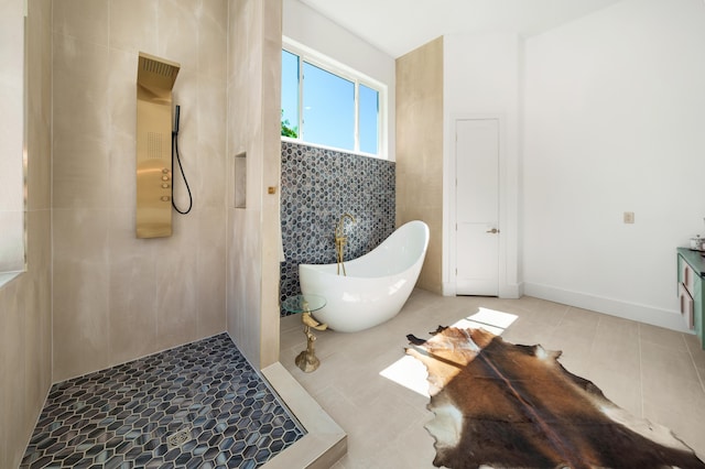 full bathroom featuring a freestanding bath, tiled shower, and tile patterned floors
