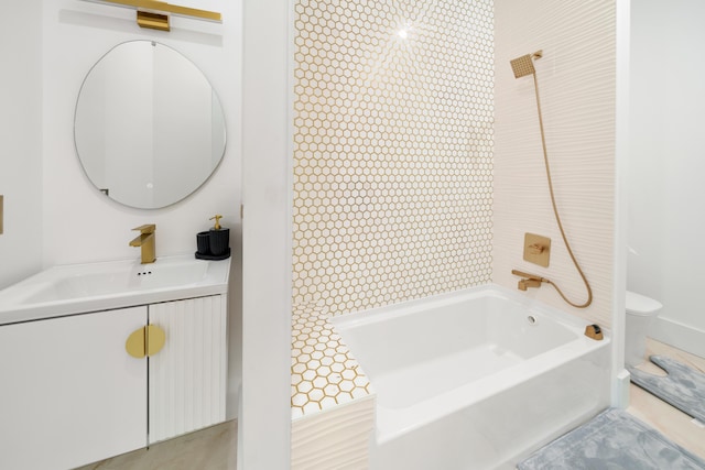 bathroom featuring toilet, vanity, and shower / tub combination