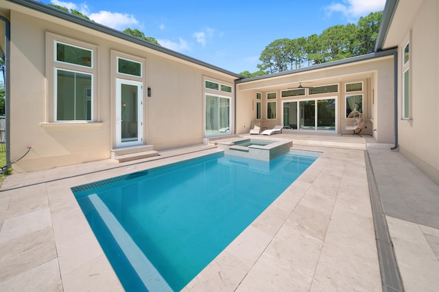 view of swimming pool featuring a patio area and a pool with connected hot tub