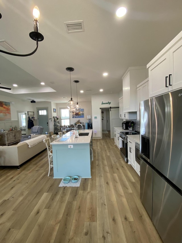 3784 Redbud Way, Panama City, FL 32404 - kitchen featuring white cabinetry, open floor plan, light wood-style floors, visible vents, and appliances with stainless steel finishes