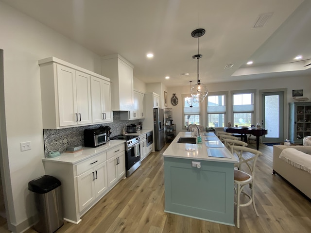 3784 Redbud Way, Panama City, FL 32404 - kitchen featuring open floor plan, a breakfast bar, backsplash, a sink, and appliances with stainless steel finishes
