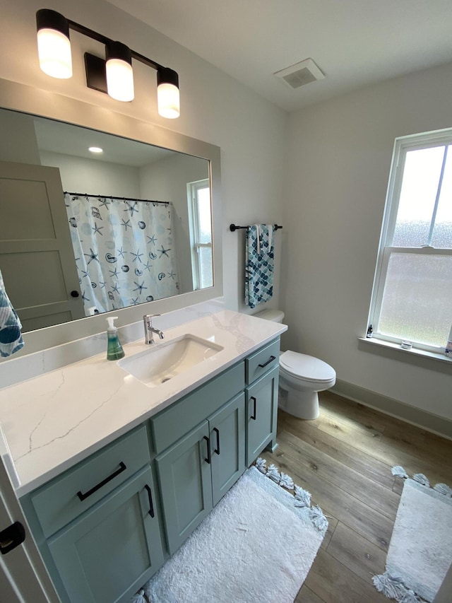 3784 Redbud Way, Panama City, FL 32404 - bathroom featuring visible vents, baseboards, toilet, wood finished floors, and vanity