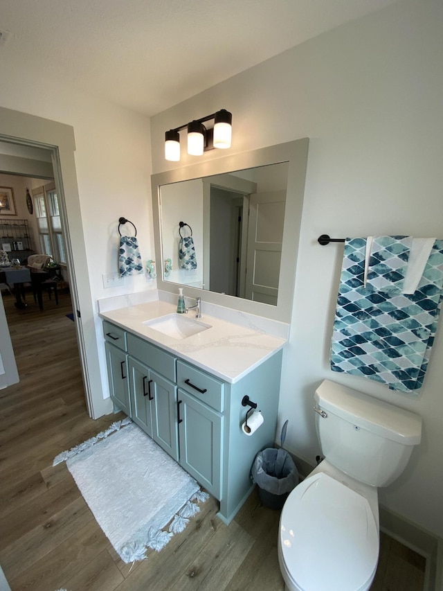 3784 Redbud Way, Panama City, FL 32404 - bathroom with toilet, vanity, wood finished floors, baseboards, and visible vents