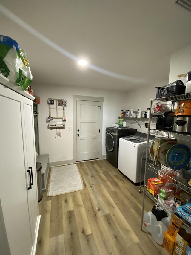 3784 Redbud Way, Panama City, FL 32404 - clothes washing area with baseboards, separate washer and dryer, light wood finished floors, visible vents, and laundry area