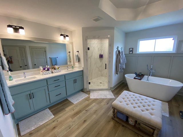 3784 Redbud Way, Panama City, FL 32404 - full bathroom with double vanity, a sink, a stall shower, and wood finished floors