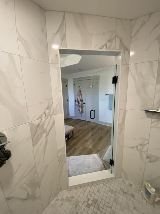 3784 Redbud Way, Panama City, FL 32404 - bathroom with wood finished floors, tile walls, and a shower stall