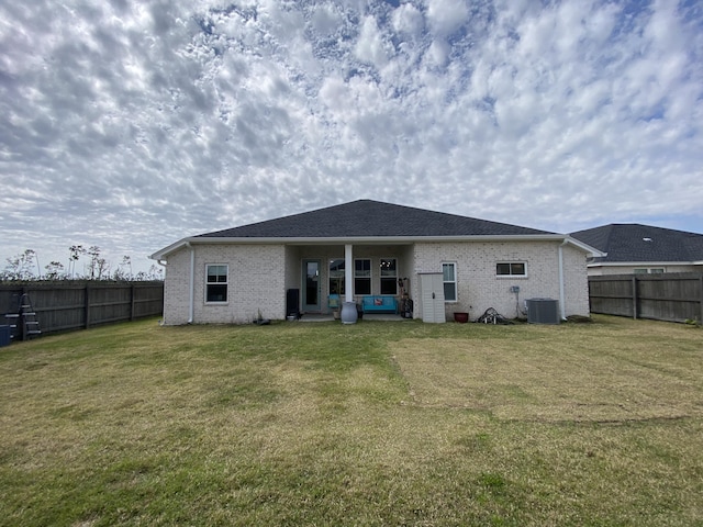3784 Redbud Way, Panama City, FL 32404 - back of property featuring cooling unit, a fenced backyard, brick siding, and a lawn
