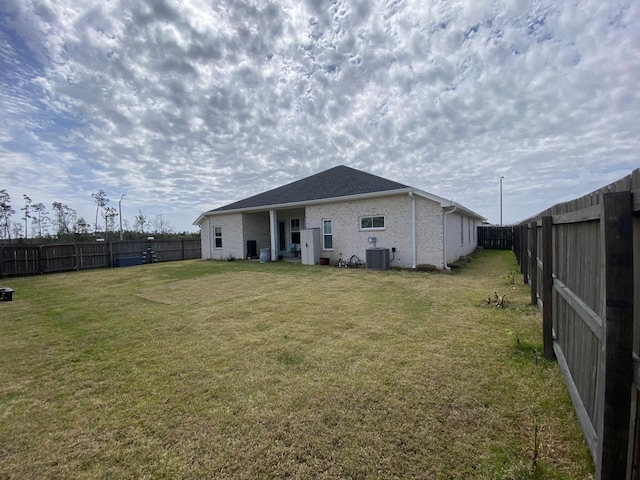 3784 Redbud Way, Panama City, FL 32404 - rear view of house with a fenced backyard, brick siding, central air condition unit, and a lawn