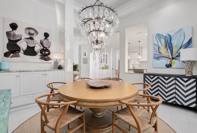 dining area with light tile patterned flooring, a notable chandelier, and crown molding