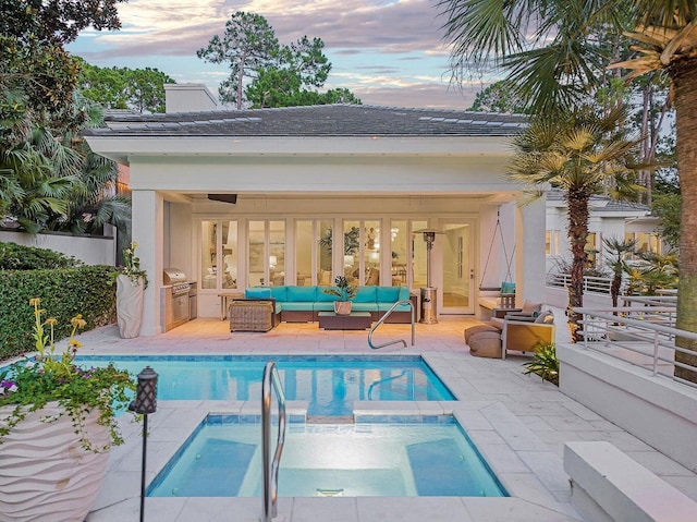 view of swimming pool with a pool with connected hot tub, a patio area, area for grilling, outdoor lounge area, and grilling area