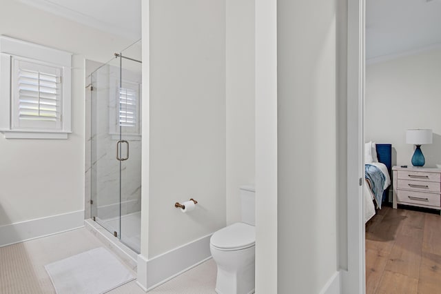 full bathroom featuring ensuite bathroom, a shower stall, baseboards, ornamental molding, and toilet