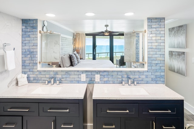291 Scenic Gulf Dr Unit 1405, Miramar Beach, FL 32550 - ensuite bathroom featuring a sink, decorative backsplash, and two vanities