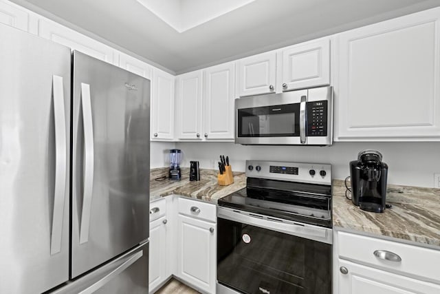 8575 Gulf Blvd Unit 1402, Navarre, FL 32566 - kitchen with white cabinetry, light stone countertops, and appliances with stainless steel finishes