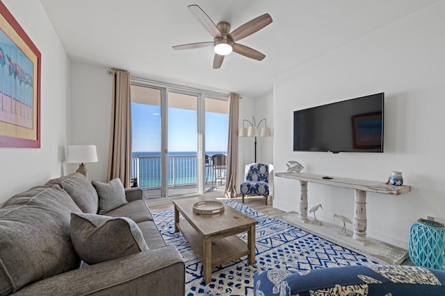 8575 Gulf Blvd Unit 1402, Navarre, FL 32566 - living room with expansive windows, wood finished floors, and a ceiling fan