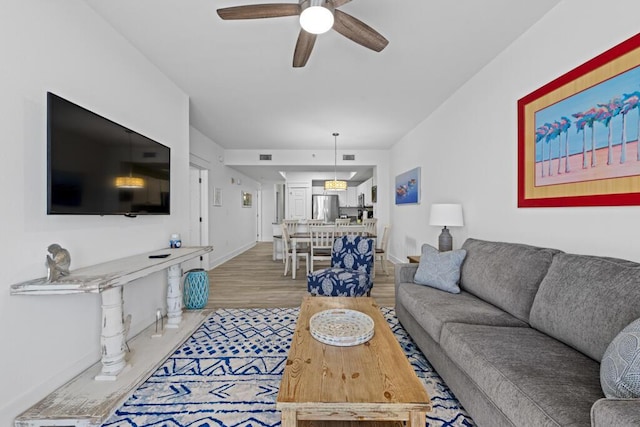 8575 Gulf Blvd Unit 1402, Navarre, FL 32566 - living area featuring a ceiling fan, visible vents, baseboards, and wood finished floors