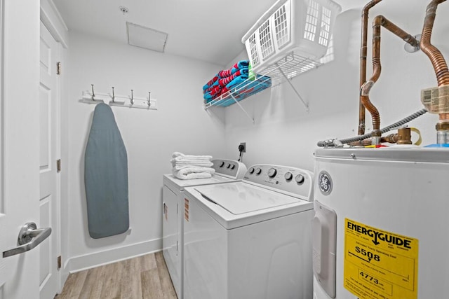 8575 Gulf Blvd Unit 1402, Navarre, FL 32566 - laundry room featuring water heater, washer and clothes dryer, attic access, baseboards, and light wood-style flooring