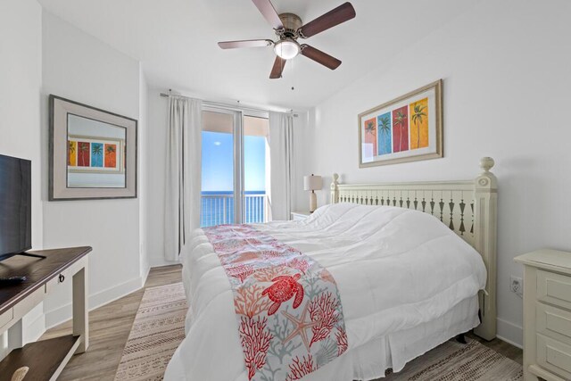 8575 Gulf Blvd Unit 1402, Navarre, FL 32566 - bedroom featuring baseboards, access to outside, a ceiling fan, and wood finished floors