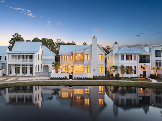 267 Tyler Dr, Santa Rosa Beach, FL 32459 - back of property at dusk with a residential view, a balcony, and a water view