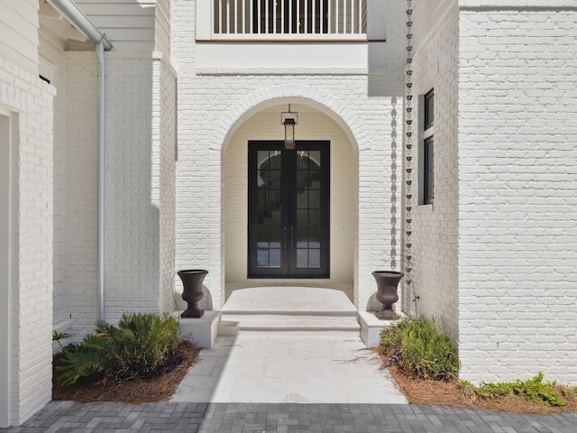 267 Tyler Dr, Santa Rosa Beach, FL 32459 - property entrance with a balcony, brick siding, and french doors