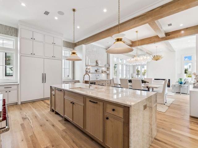 267 Tyler Dr, Santa Rosa Beach, FL 32459 - kitchen featuring a notable chandelier, a spacious island, a sink, beamed ceiling, and light wood-style floors