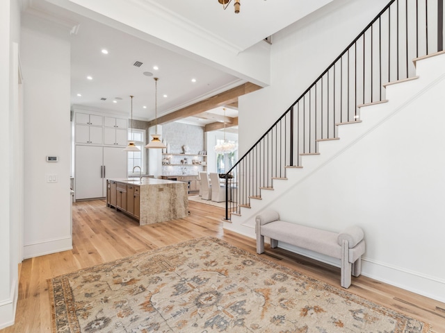 267 Tyler Dr, Santa Rosa Beach, FL 32459 - interior space featuring stairs, a notable chandelier, light wood-style floors, and baseboards