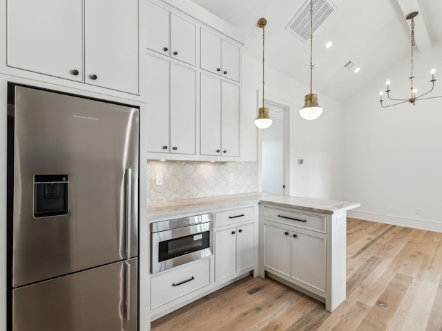 267 Tyler Dr, Santa Rosa Beach, FL 32459 - kitchen with decorative backsplash, visible vents, stainless steel fridge, and light wood finished floors