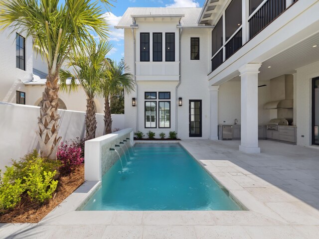 267 Tyler Dr, Santa Rosa Beach, FL 32459 - outdoor pool with an outdoor kitchen, a patio, fence, and grilling area