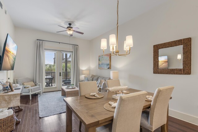 dining area featuring dark wood-type flooring, baseboards, and ceiling fan with notable chandelier