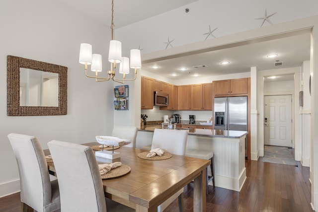 dining space featuring dark wood-style flooring, baseboards, visible vents, recessed lighting, and an inviting chandelier