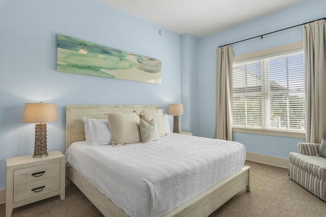 bedroom with carpet flooring and baseboards