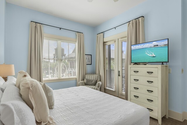 bedroom featuring baseboards, access to exterior, ceiling fan, and carpet