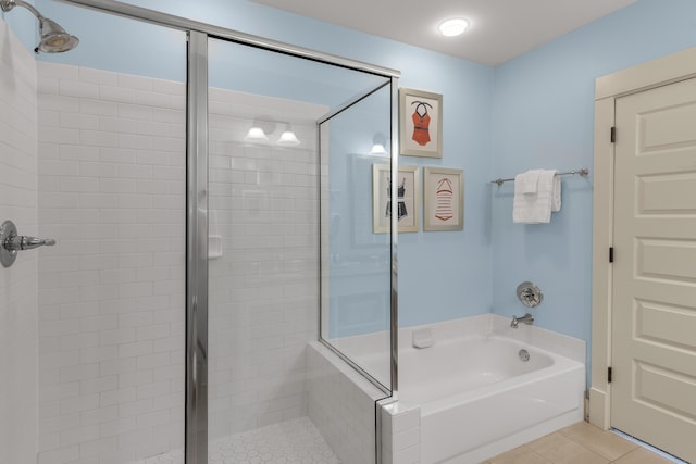 full bathroom featuring a stall shower, tile patterned floors, and a bath