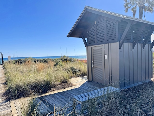 exterior space with a water view, an outbuilding, and board and batten siding