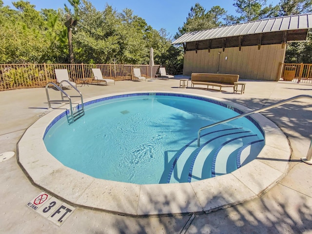 pool with fence and a patio area