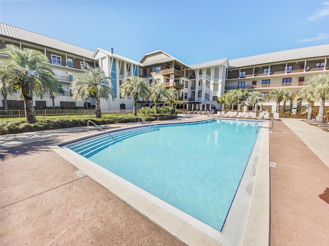 view of swimming pool with fence
