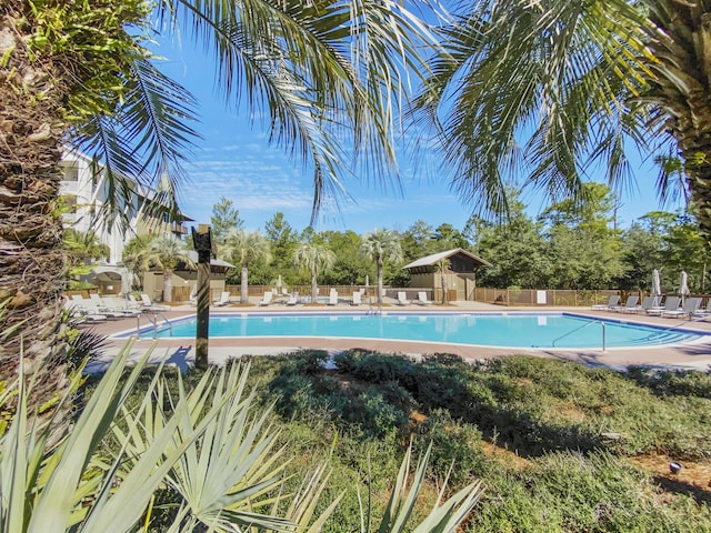 pool with fence and a patio