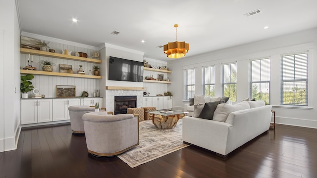 294 Gulfview Cir, Santa Rosa Beach, FL 32459 - living area with visible vents, a tile fireplace, crown molding, and dark wood-type flooring