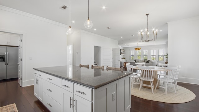 294 Gulfview Cir, Santa Rosa Beach, FL 32459 - kitchen with dark wood-style floors, visible vents, ornamental molding, stainless steel refrigerator with ice dispenser, and a center island
