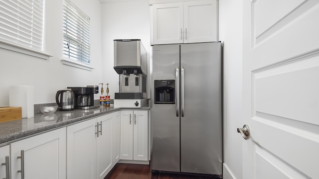 294 Gulfview Cir, Santa Rosa Beach, FL 32459 - kitchen with dark stone counters, stainless steel fridge, dark wood-style floors, and white cabinetry