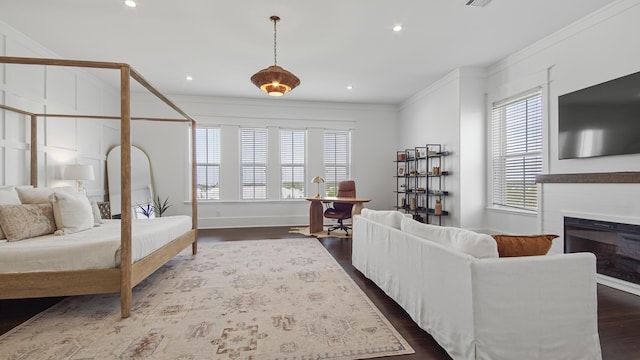 294 Gulfview Cir, Santa Rosa Beach, FL 32459 - bedroom featuring visible vents, a glass covered fireplace, dark wood-style floors, recessed lighting, and crown molding