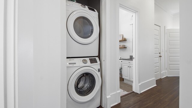 294 Gulfview Cir, Santa Rosa Beach, FL 32459 - clothes washing area featuring stacked washer and dryer and dark wood finished floors
