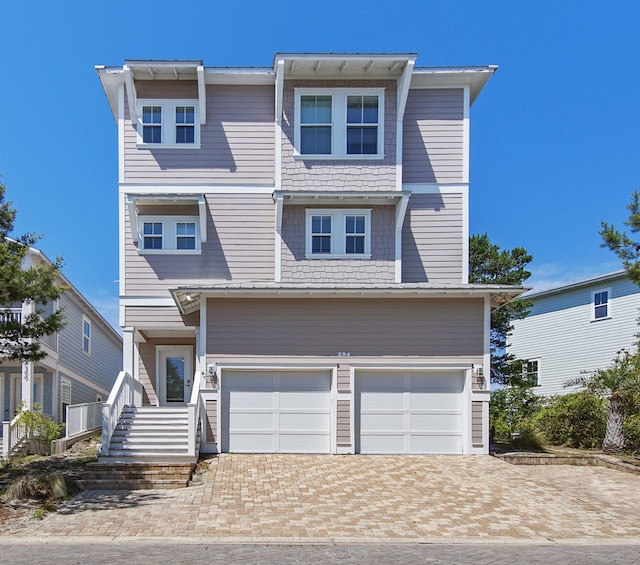 294 Gulfview Cir, Santa Rosa Beach, FL 32459 - view of front of house with decorative driveway and an attached garage