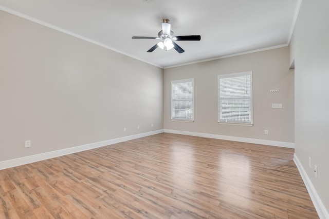 empty room with baseboards, a ceiling fan, light wood-style flooring, and crown molding