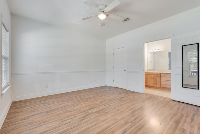 spare room with baseboards, visible vents, a ceiling fan, and light wood-style floors
