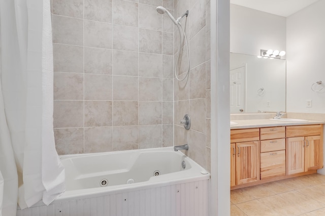 full bath with a sink, double vanity, tile patterned floors, and a combined bath / shower with jetted tub